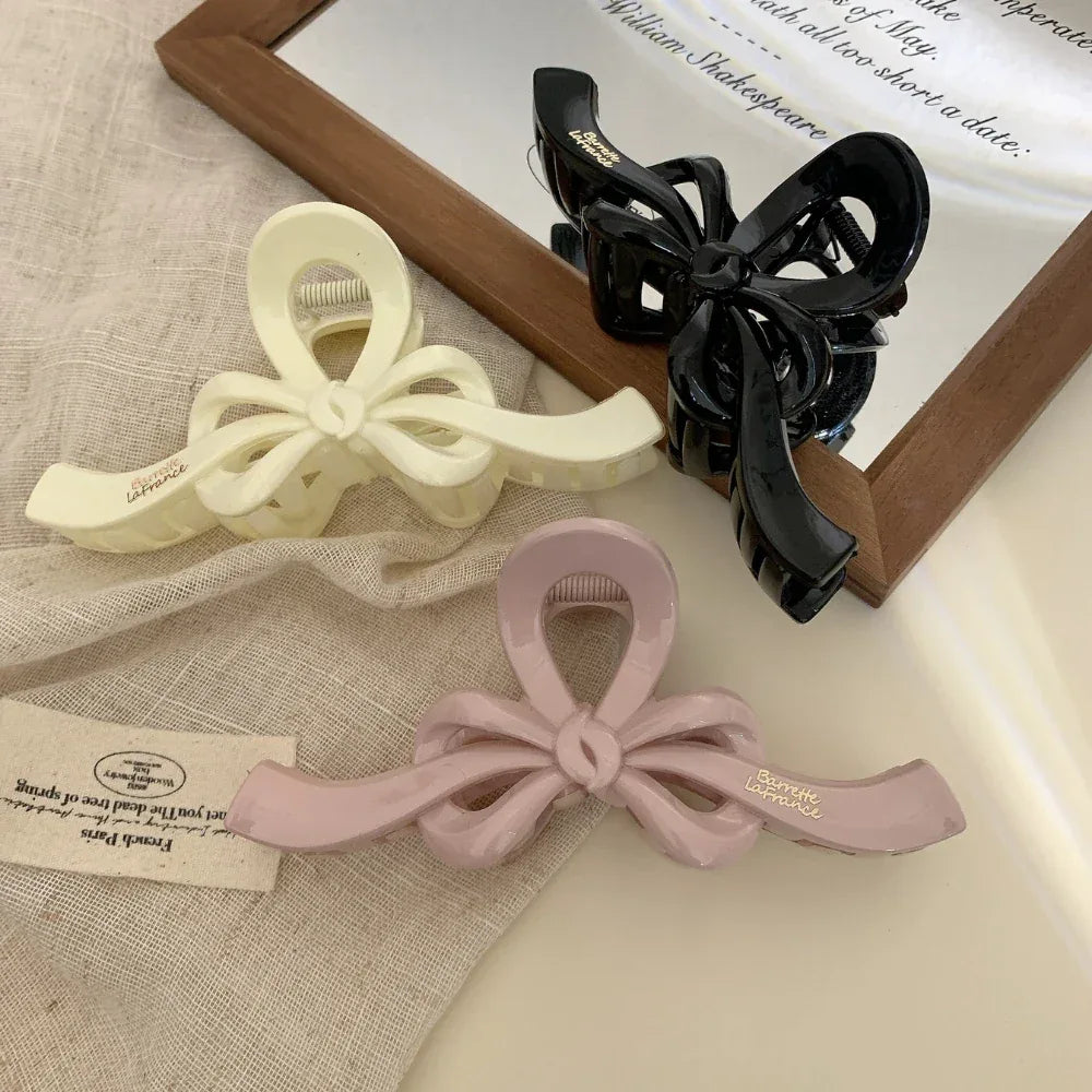 Bow claw clips displayed with fabric and paper accents