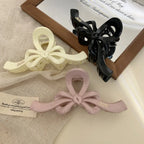 Bow claw clips displayed with fabric and paper accents