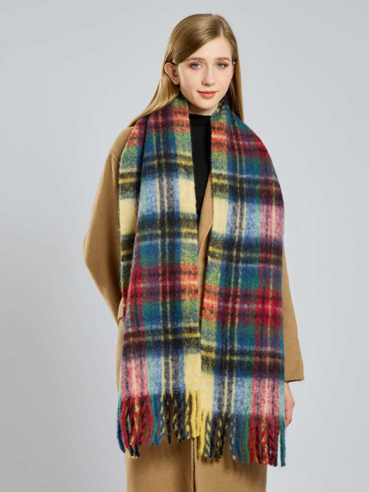 Woman wearing a plaid scarf and tan coat