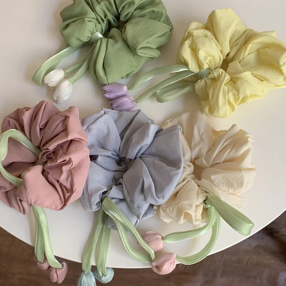 collection of oversized scrunchies in pastel colors with tulip embellishments