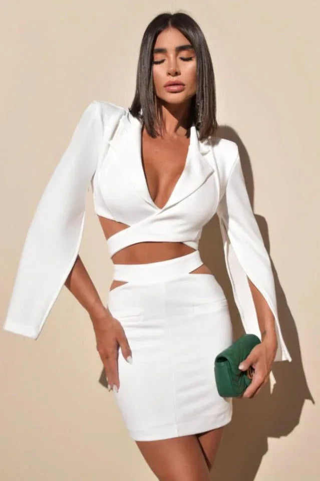 Woman wearing a white two-piece set with cut-out details and bell sleeves. Main image