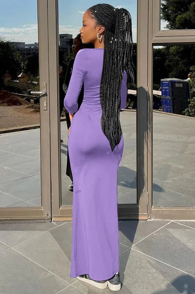back view of a woman wearing a long purple ruched dress with a flare hem
