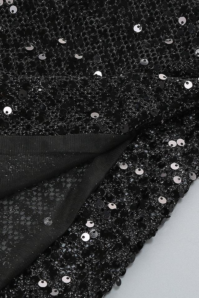 Close-up of the black sequined sheer fabric of the dress