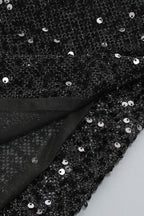 Close-up of the black sequined sheer fabric of the dress