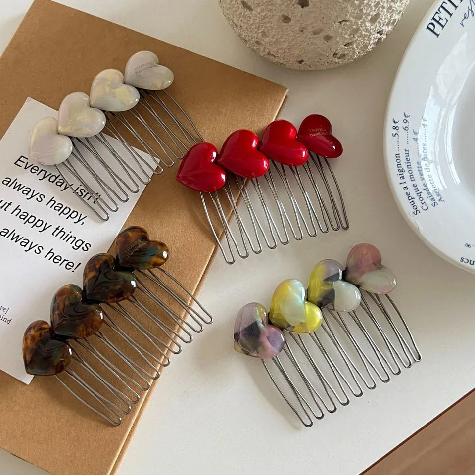Assortment of heart-shaped hair combs in various colors Secondary image