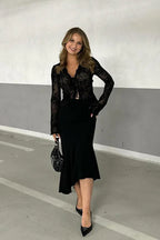 Woman wearing a black floral burnout long-sleeve top with tie-front closure and a black midi skirt