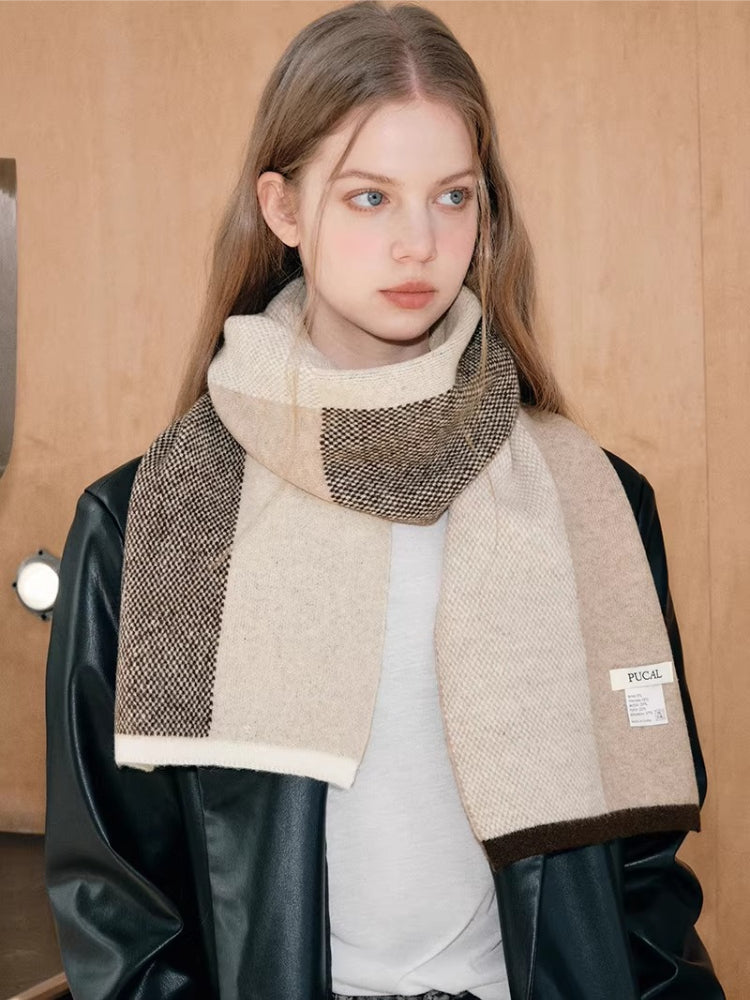 Close-up of a woman wearing a textured plaid scarf.