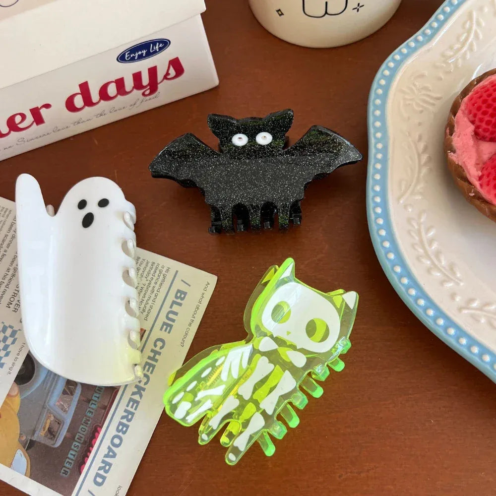 Collection of Halloween-themed hair clips including a skeleton cat, ghost, and bat