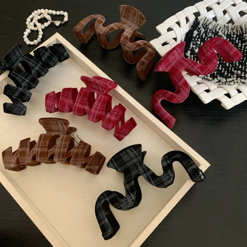 Selection of plaid velvet hair clips displayed in a wooden tray