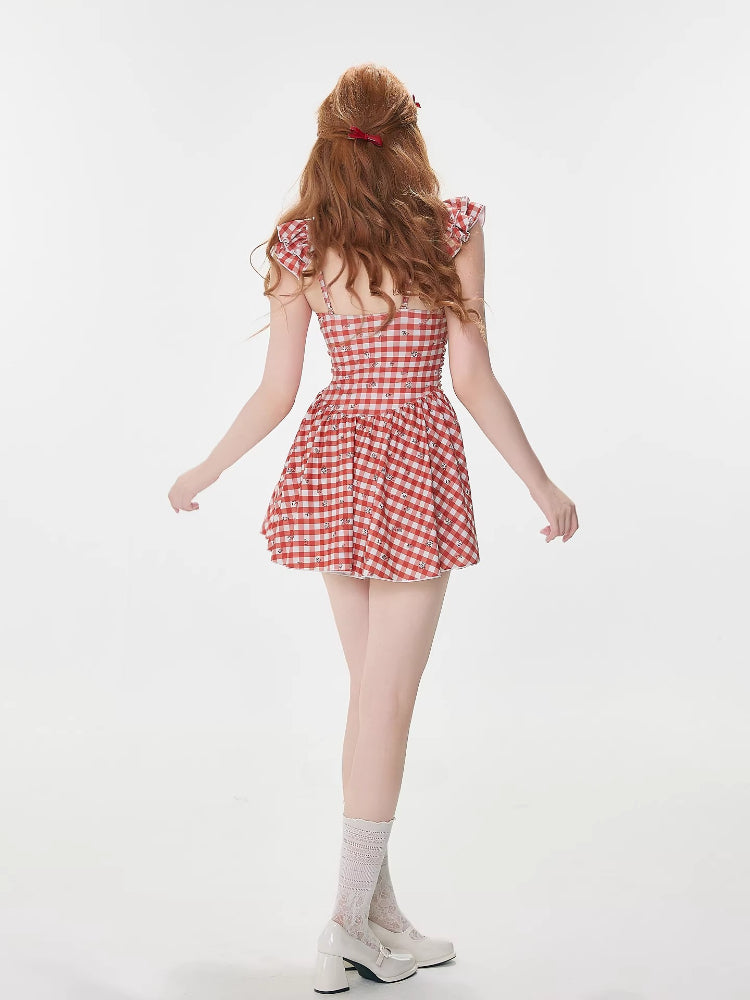 Rear view of a woman wearing a red and white gingham dress with ruffled sleeves.