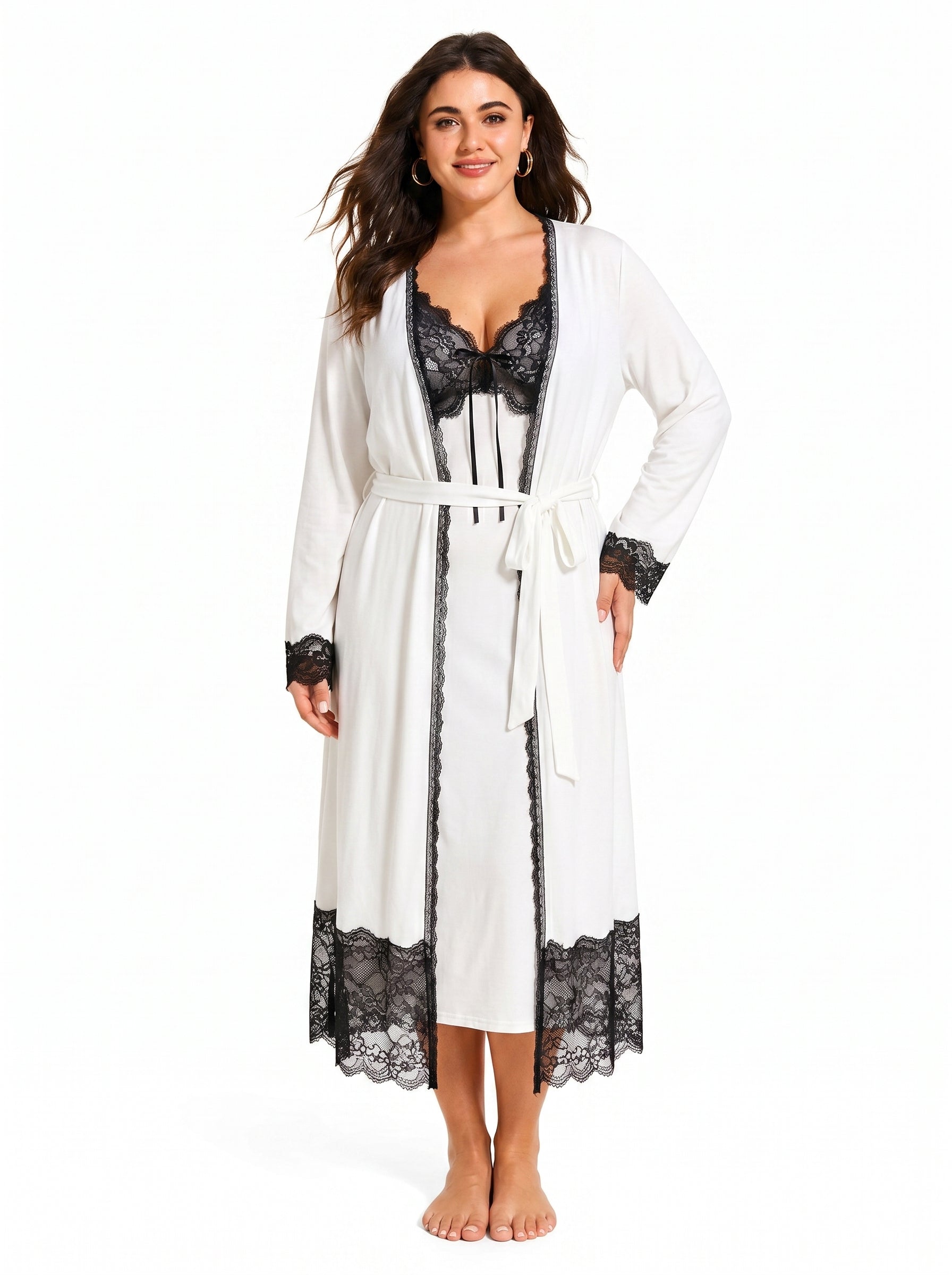 Woman wearing a white satin slip dress with black lace trim and a matching white long robe with black lace trim