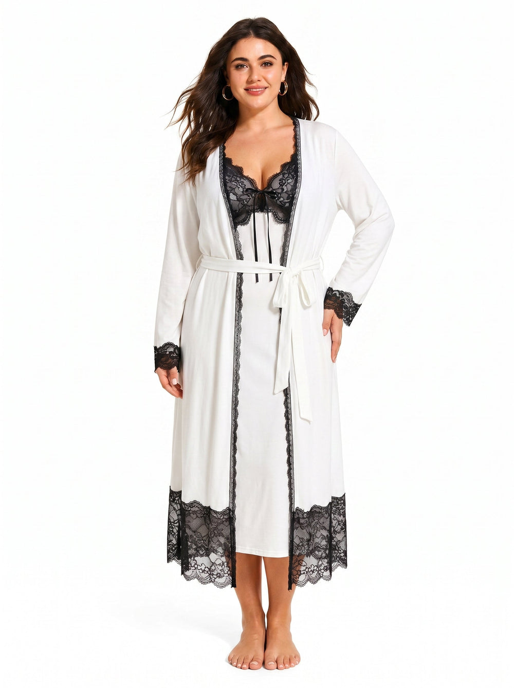 Woman wearing a white satin slip dress with black lace trim and a matching white long robe with black lace trim