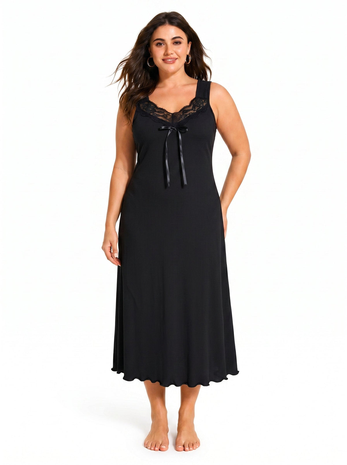 Woman wearing a black ribbed knit nightgown with lace trim and a bow
