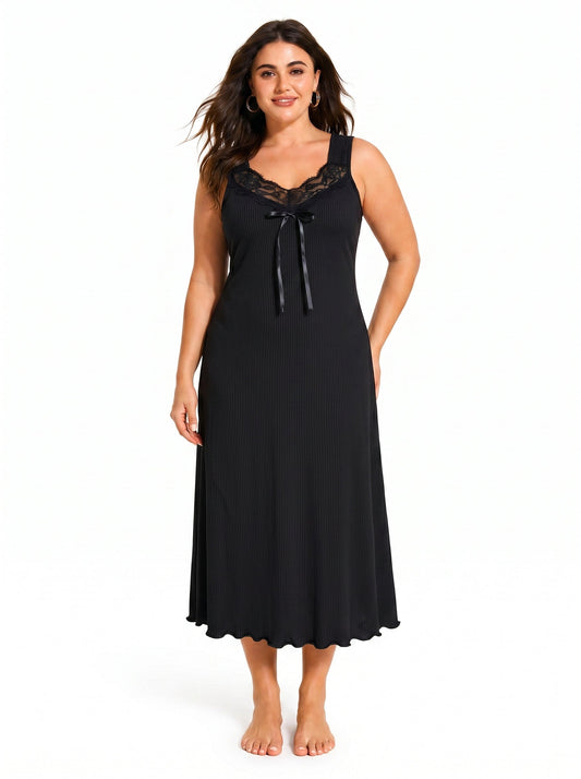 Woman wearing a black ribbed knit nightgown with lace trim and a bow