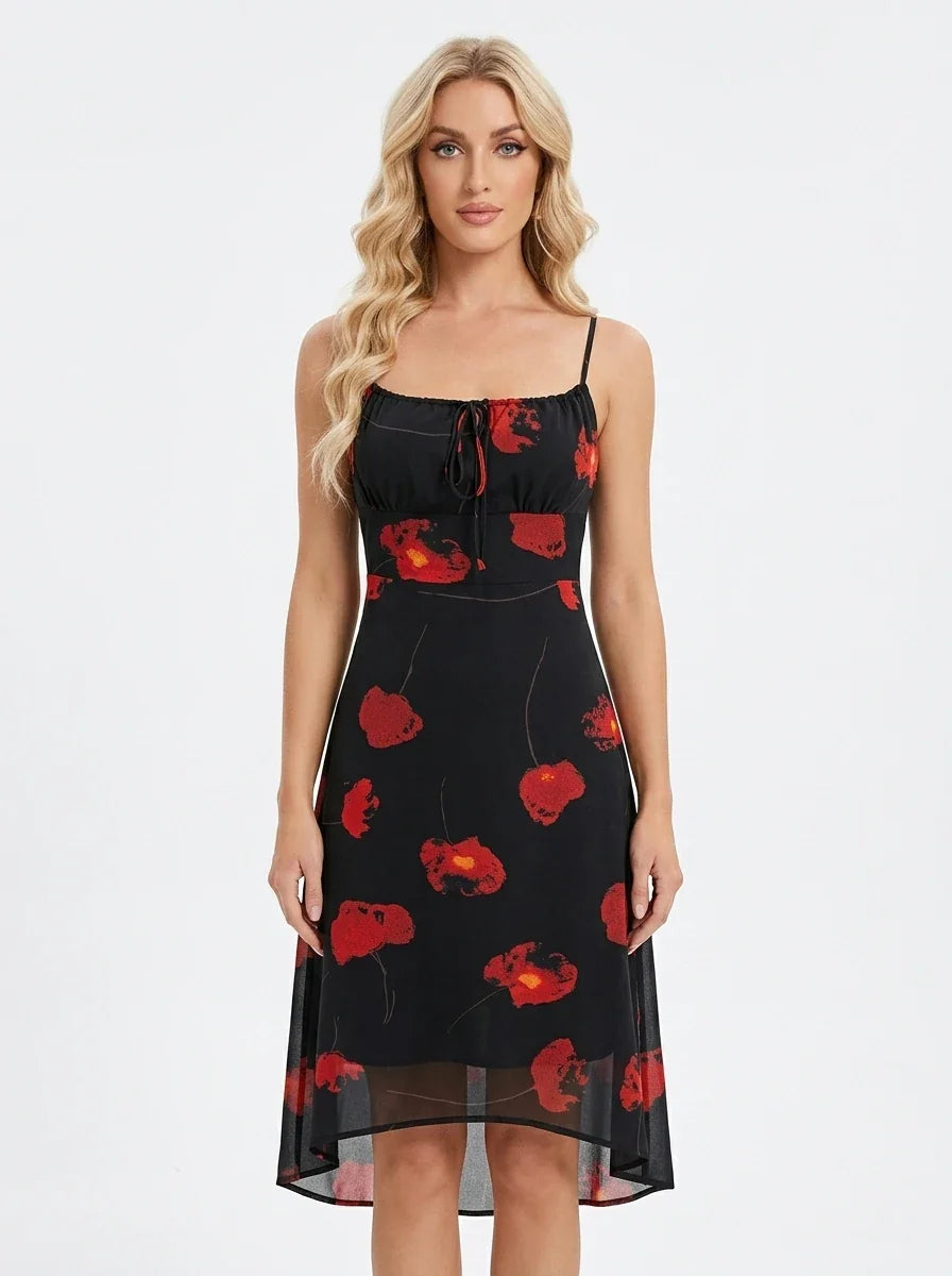Woman wearing a black sleeveless midi dress with a red floral print and spaghetti straps.