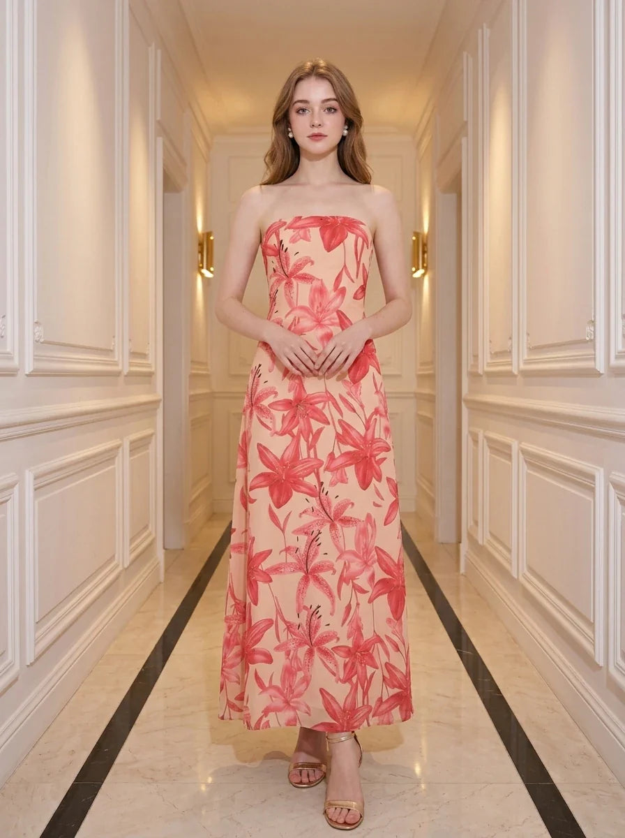 Woman standing in a hallway wearing a strapless floral print midi dress.