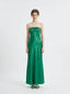 Woman standing in a green strapless satin gown with a pleated bodice, front view