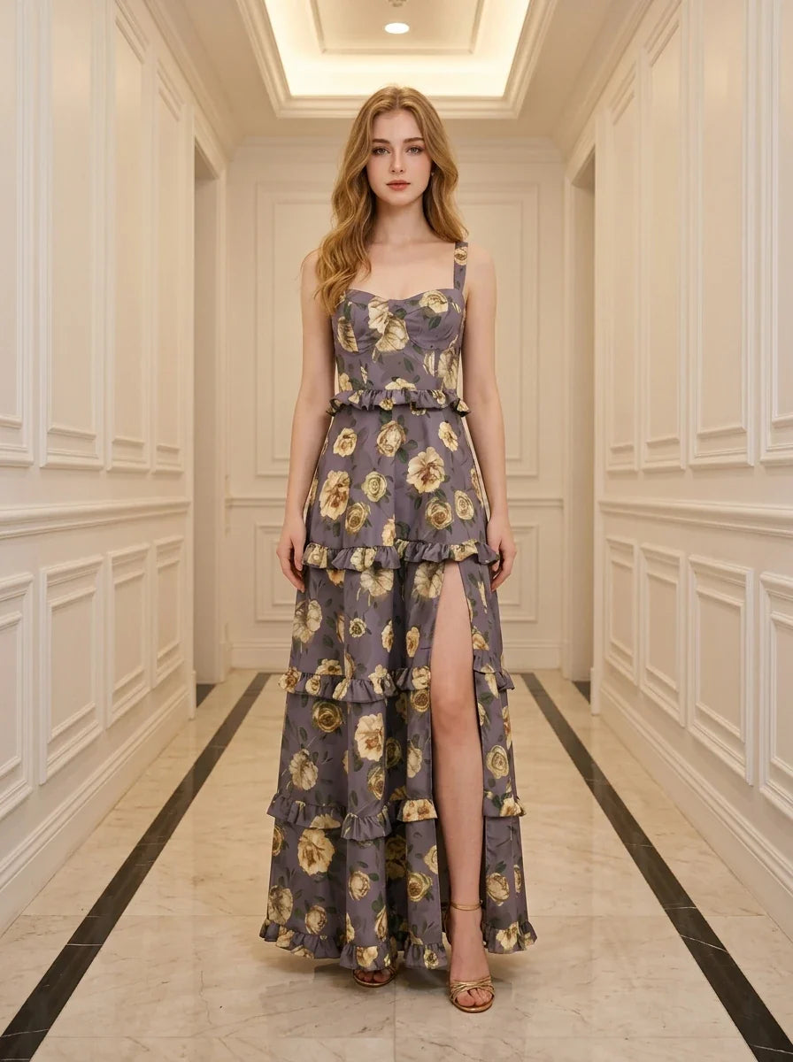 Woman standing in a hallway wearing a floral print maxi dress with a high slit