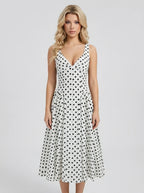 Woman wearing a white polka dot dress
