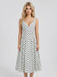 Woman wearing a white polka dot dress