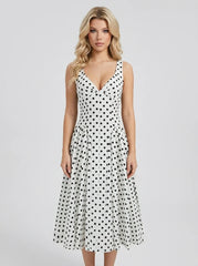 Woman wearing a white polka dot dress