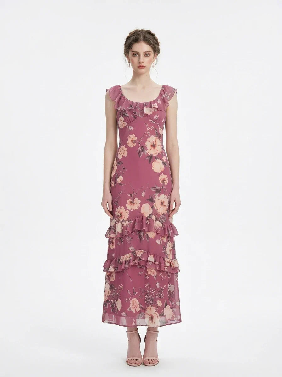 Woman wearing a pink floral print maxi dress with ruffle trim, front view