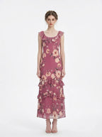 Woman wearing a pink floral print maxi dress with ruffle trim, front view