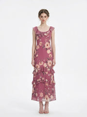 Woman wearing a pink floral print maxi dress with ruffle trim, front view