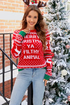 Woman wearing a red Christmas sweater with "Merry Christmas Ya Filthy Animal" text and reindeer graphics, standing next to a decorated Christmas tree.