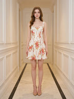 Woman standing in a hallway wearing a floral print fit and flare dress