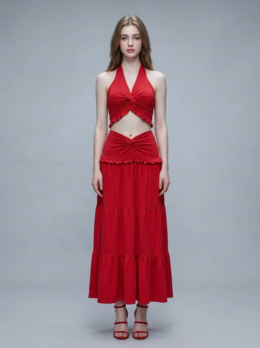 Woman wearing a red halter crop top and a tiered maxi skirt, front view