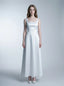 Woman wearing a white satin sleeveless A-line wedding dress with a square neckline, front view