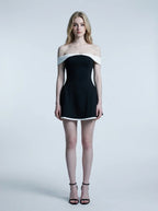woman in black and white off-the-shoulder dress standing
