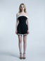 woman in black and white off-the-shoulder dress standing