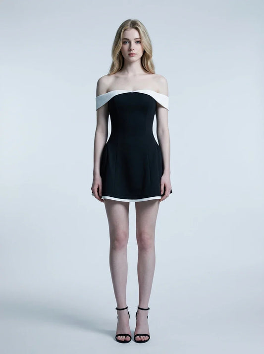 woman in black and white off-the-shoulder dress standing