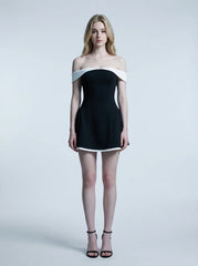 woman in black and white off-the-shoulder dress standing