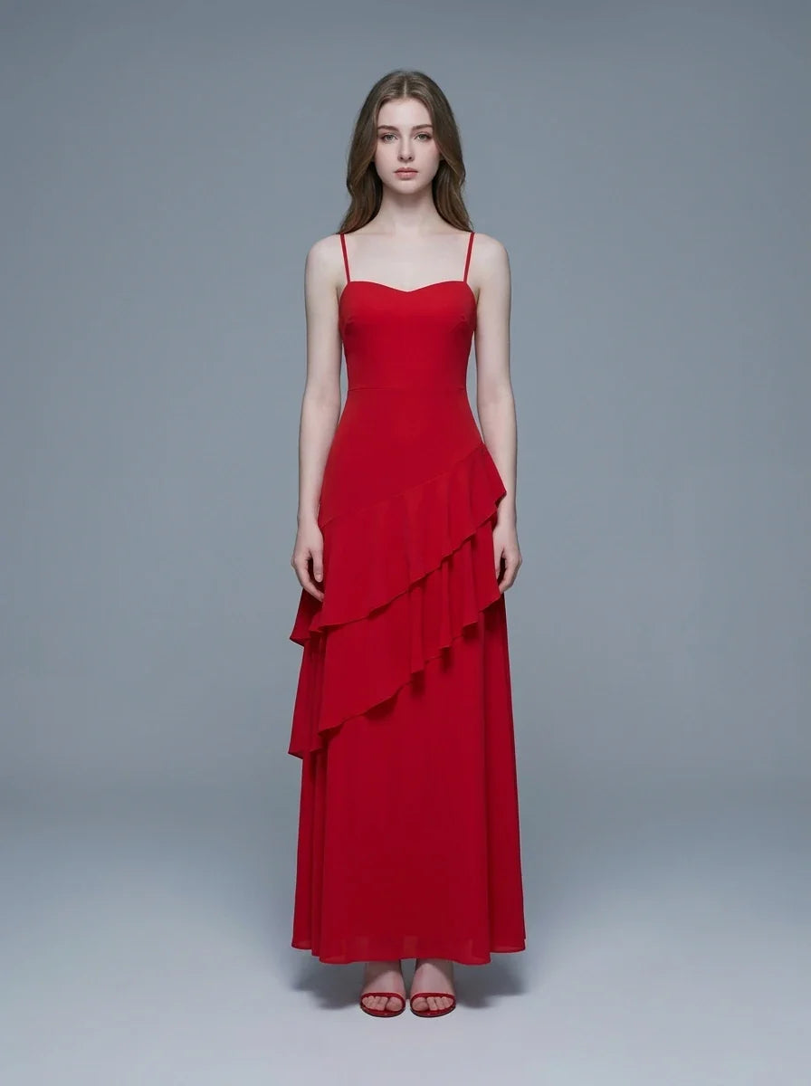 Woman wearing a red floor-length chiffon dress with tiered ruffles and spaghetti straps, front view.