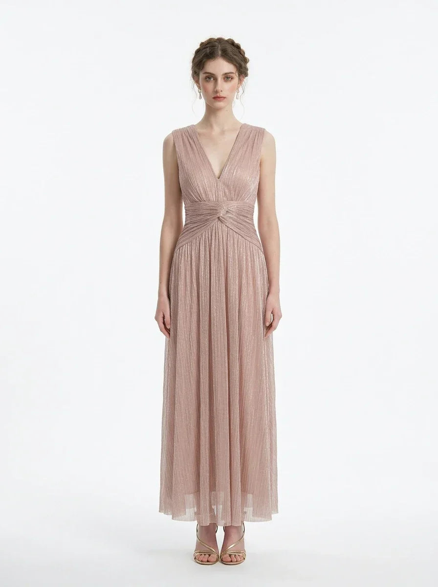 Woman in a rose gold shimmering metallic A-line V-neck sleeveless floor-length formal gown, front view