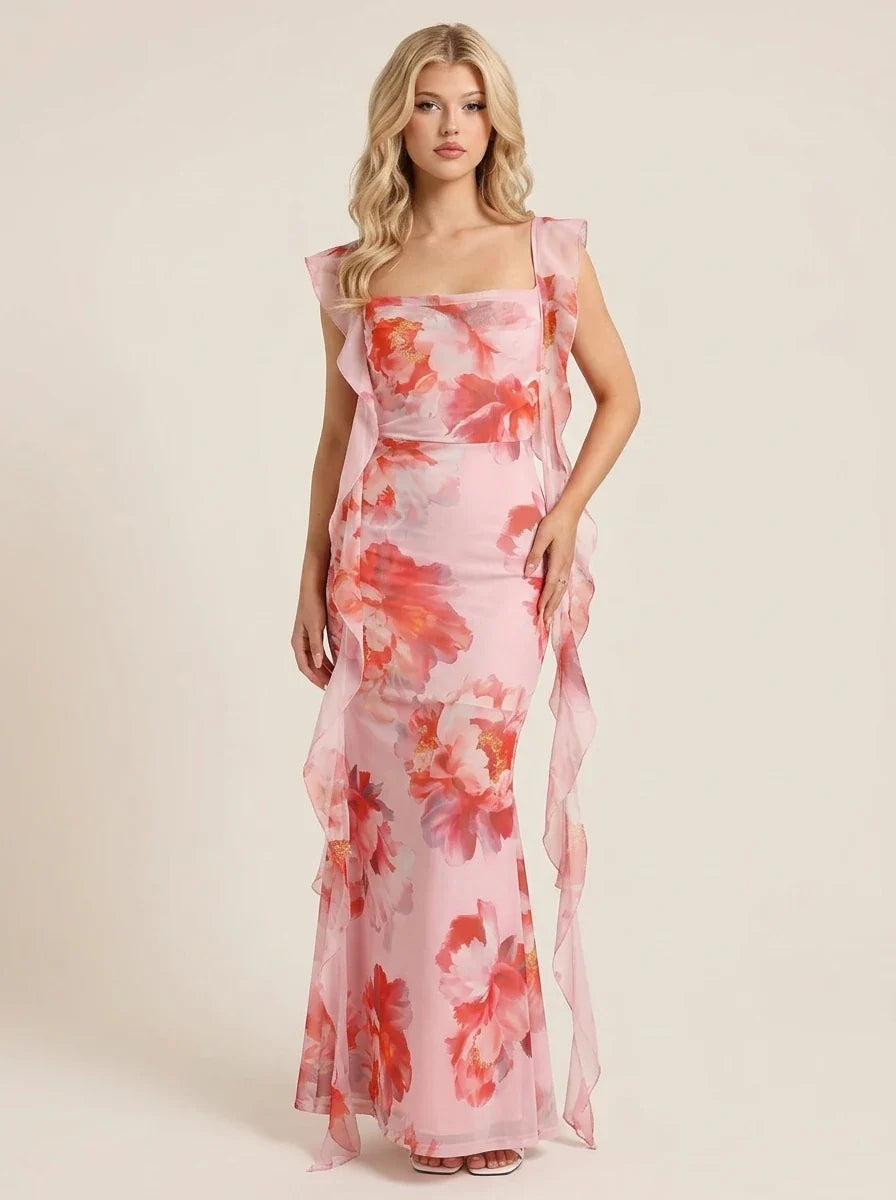 Woman wearing a pink floral print maxi dress with ruffle trim