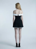 back view of woman in black and white off-the-shoulder dress