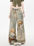 Front view of wide leg jeans with teddy bear graphic print and tie waist
