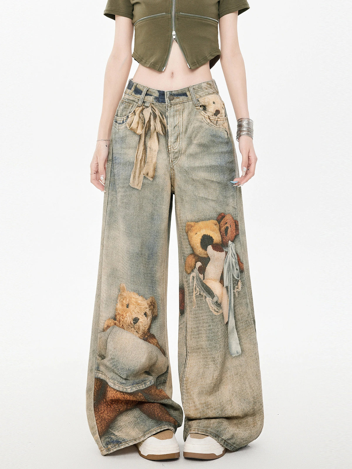 Front view of wide leg jeans with teddy bear graphic print and tie waist