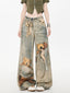 Front view of wide leg jeans with teddy bear graphic print and tie waist
