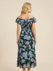 Back view of a woman in a black off-the-shoulder midi dress with a blue floral print and smocked bodice