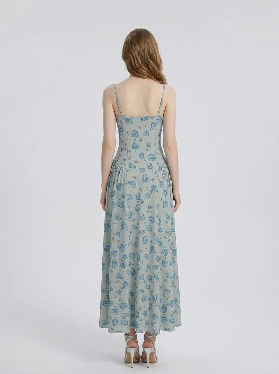 Back view of a woman in a light blue floral print midi dress.