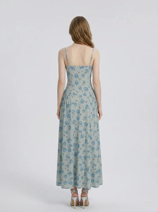 Back view of a woman in a light blue floral print midi dress.