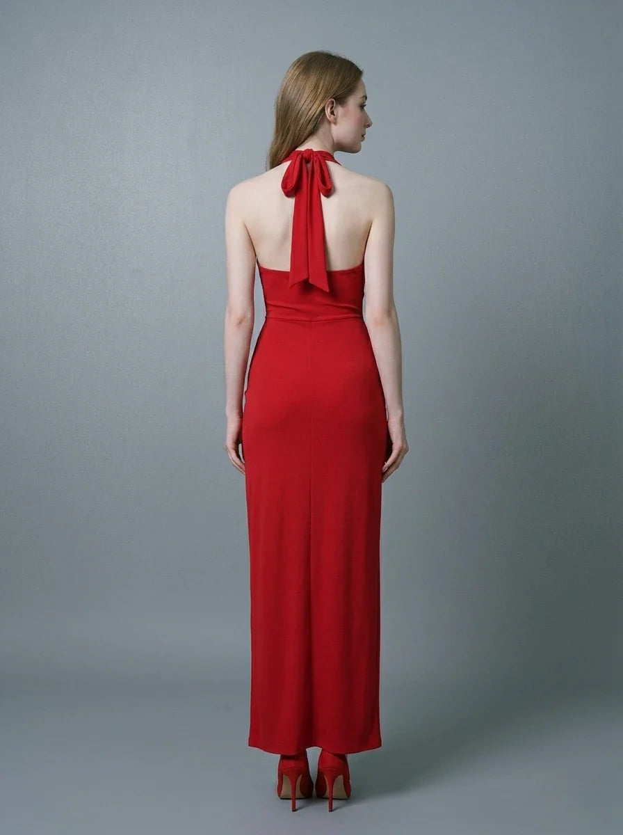 Back view of a woman in a red halter neck gown