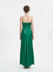 Woman standing in a green strapless satin gown with a pleated bodice, back view