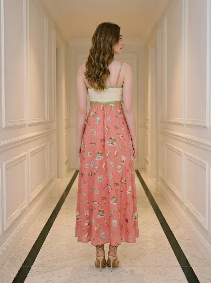 Back view of a woman in a coral A-line midi dress with spaghetti straps and a square neckline, standing in a hallway.