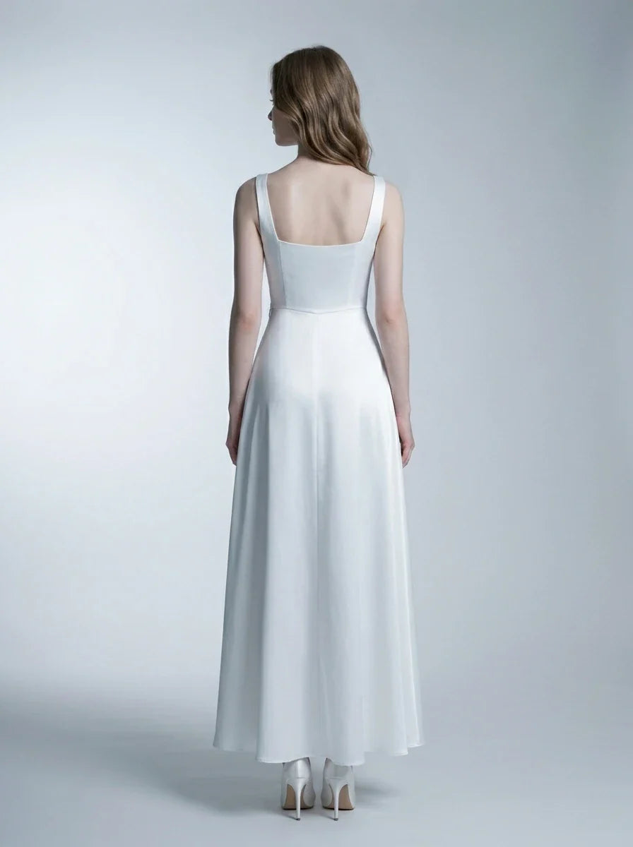 Woman wearing a white satin sleeveless A-line wedding dress with a square neckline, back view